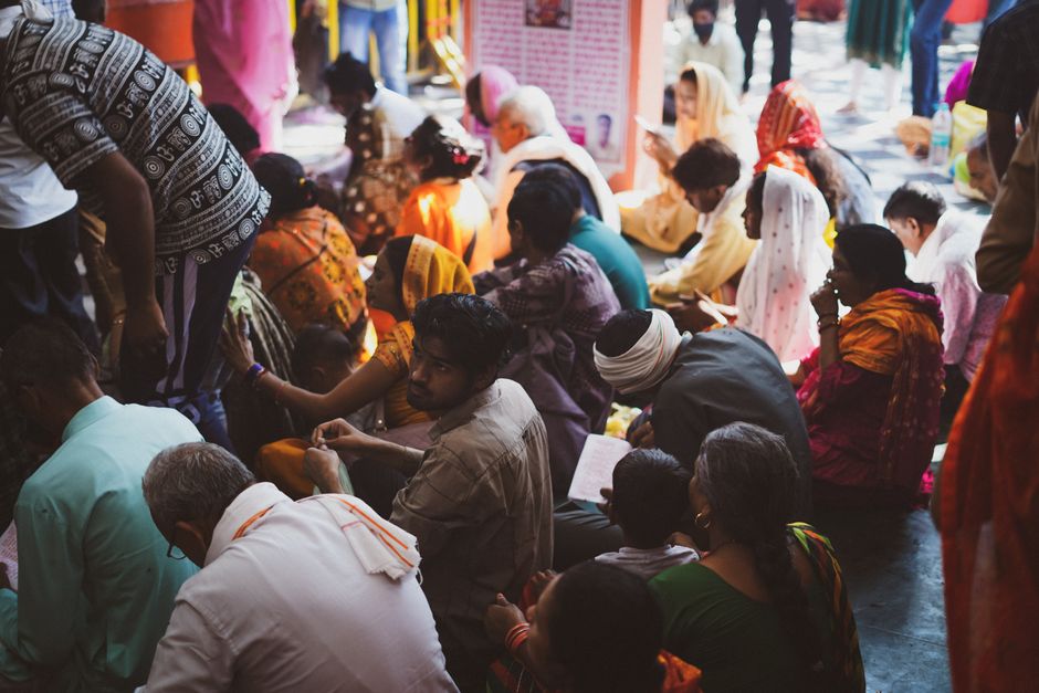 A vibrant outdoor gathering of people participating in a religious ceremony, embodying cultural diversity and devotion.