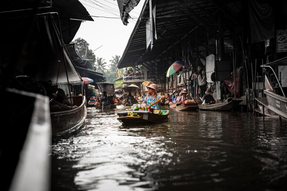 Colorful floating market with boats and vendors in Thailand's canals.