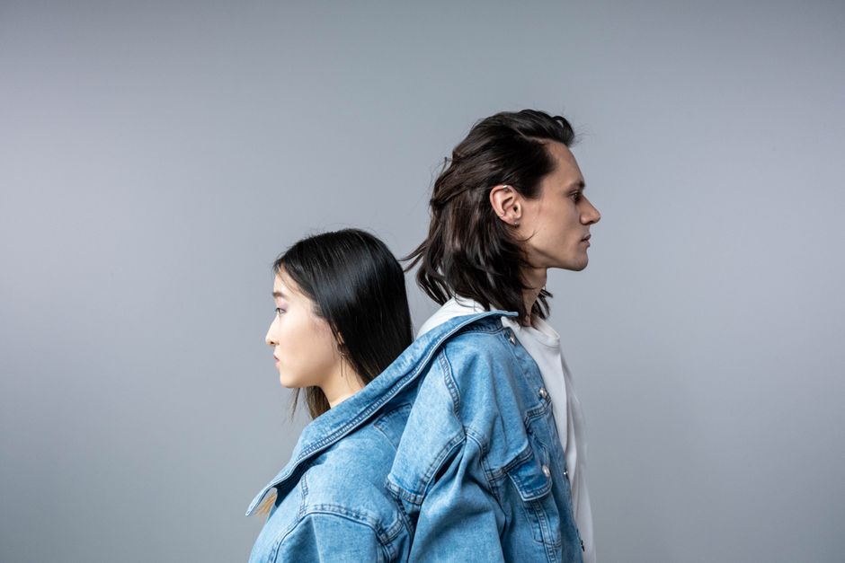 Stylish portrait featuring a man and woman wearing denim jackets, showcasing modern fashion.