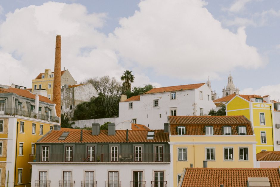 Charming view of traditional colorful buildings in Lisbon under a blue sky.