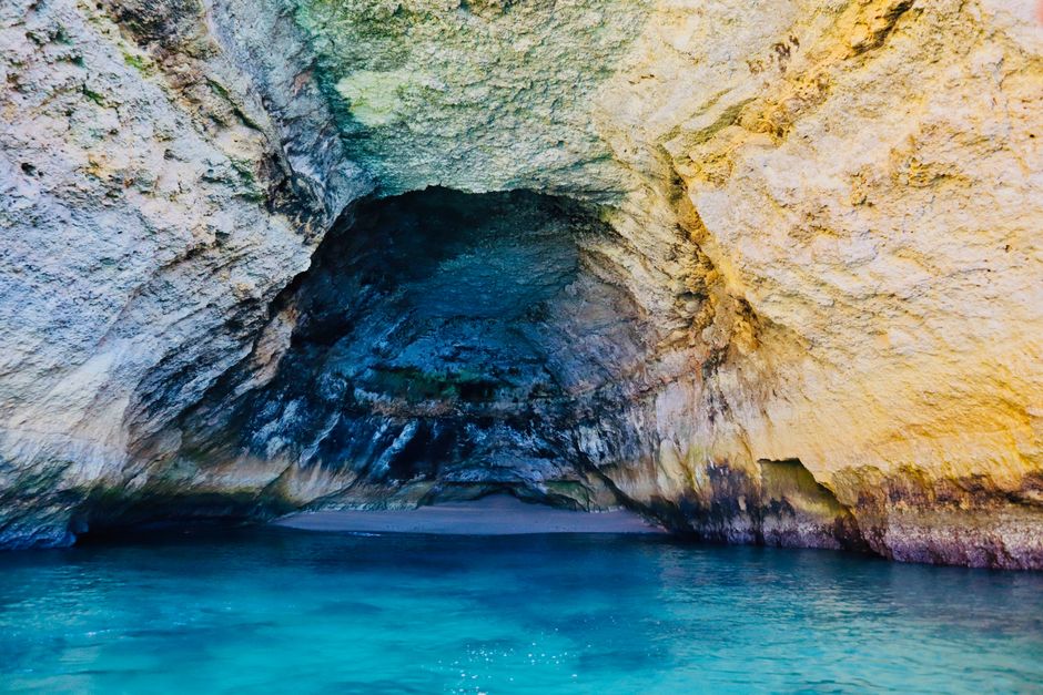 Beautiful sea cave with sparkling blue waters in Carvoeiro, Algarve, Portugal.