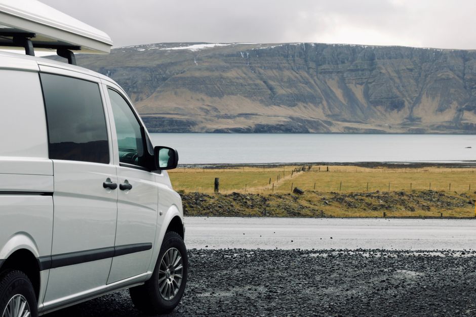 Explore the beauty of Iceland on a road trip with this captivating lake view and camper van.