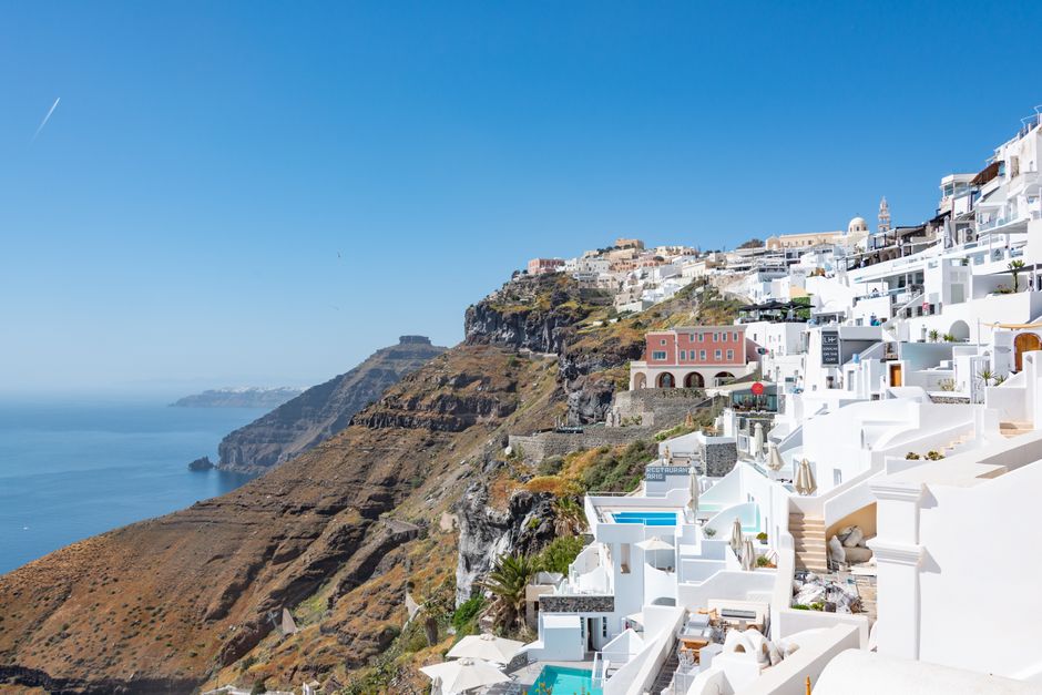 Stunning view of Santorini's iconic white buildings on a cliff overlooking the Aegean Sea.