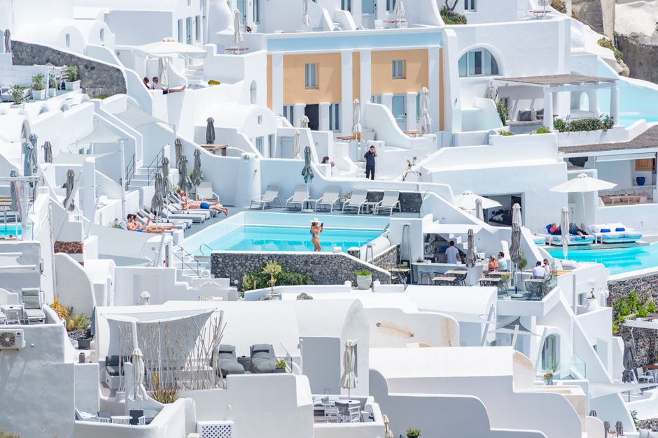 Stunning white architecture with pools in a luxurious Santorini resort.