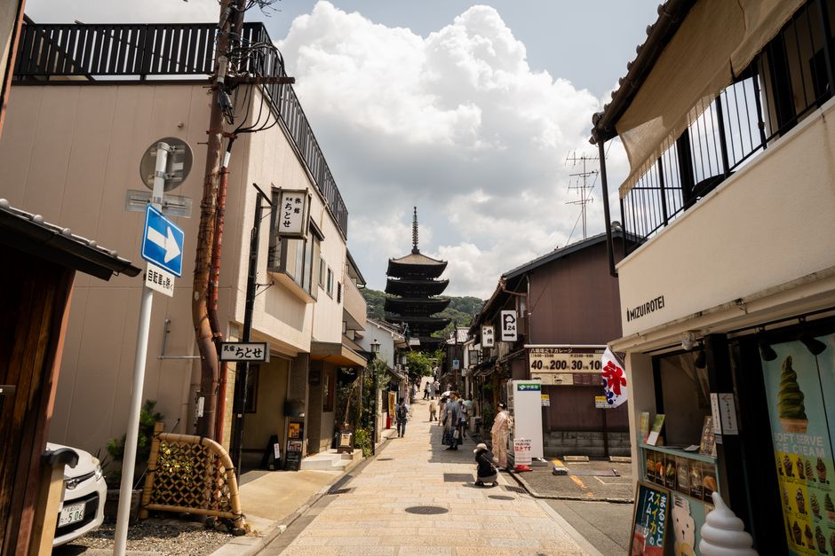 Quaint streets of Kyoto showcasing Yasaka Pagoda under a cloudy sky, capturing traditional architecture.