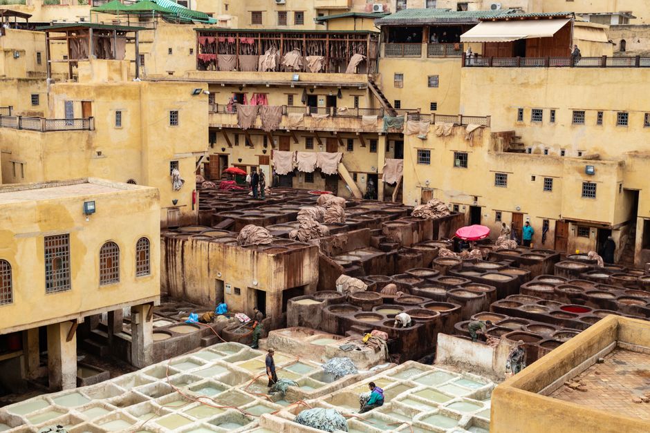 Aerial view of a traditional leather tannery in Morocco, showcasing vibrant processes.