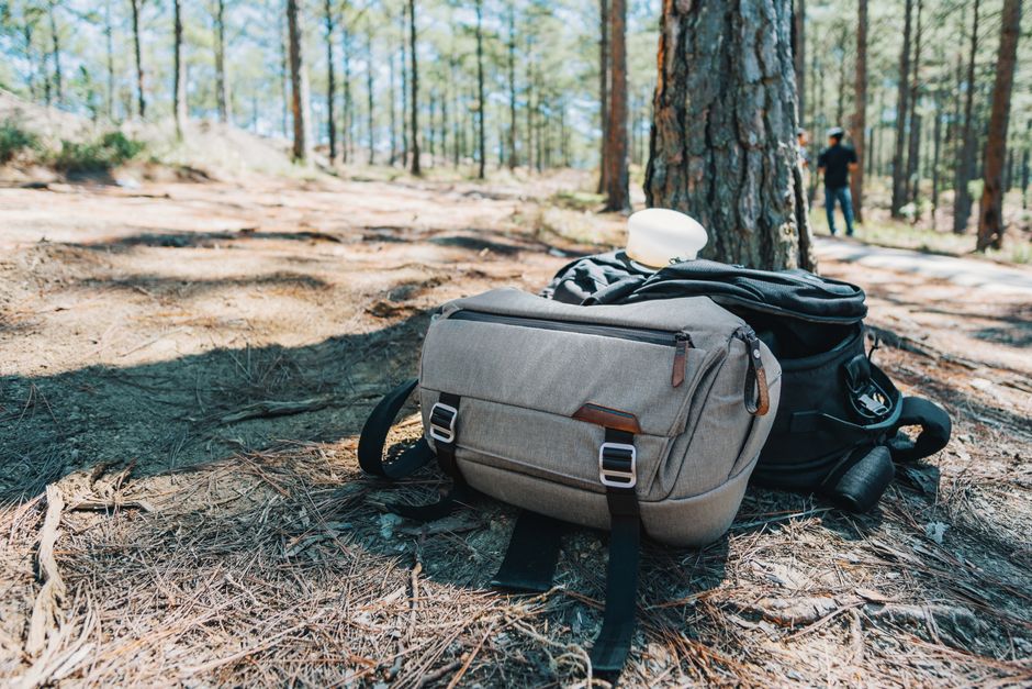 Backpack resting in a forest setting, perfect for travel and adventure lovers.